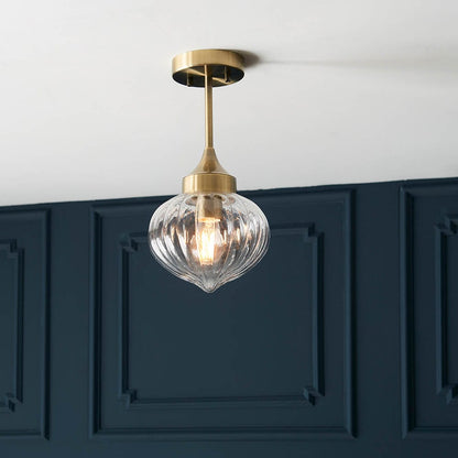 Addington brass ceiling light styled in a dark panelled interior