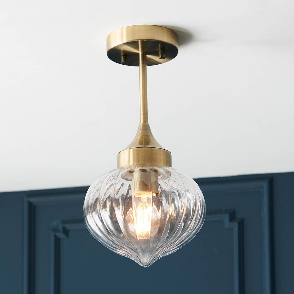 Addington antique brass ceiling light styled in a living room