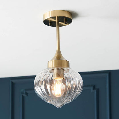 Addington antique brass ceiling light styled in a living room