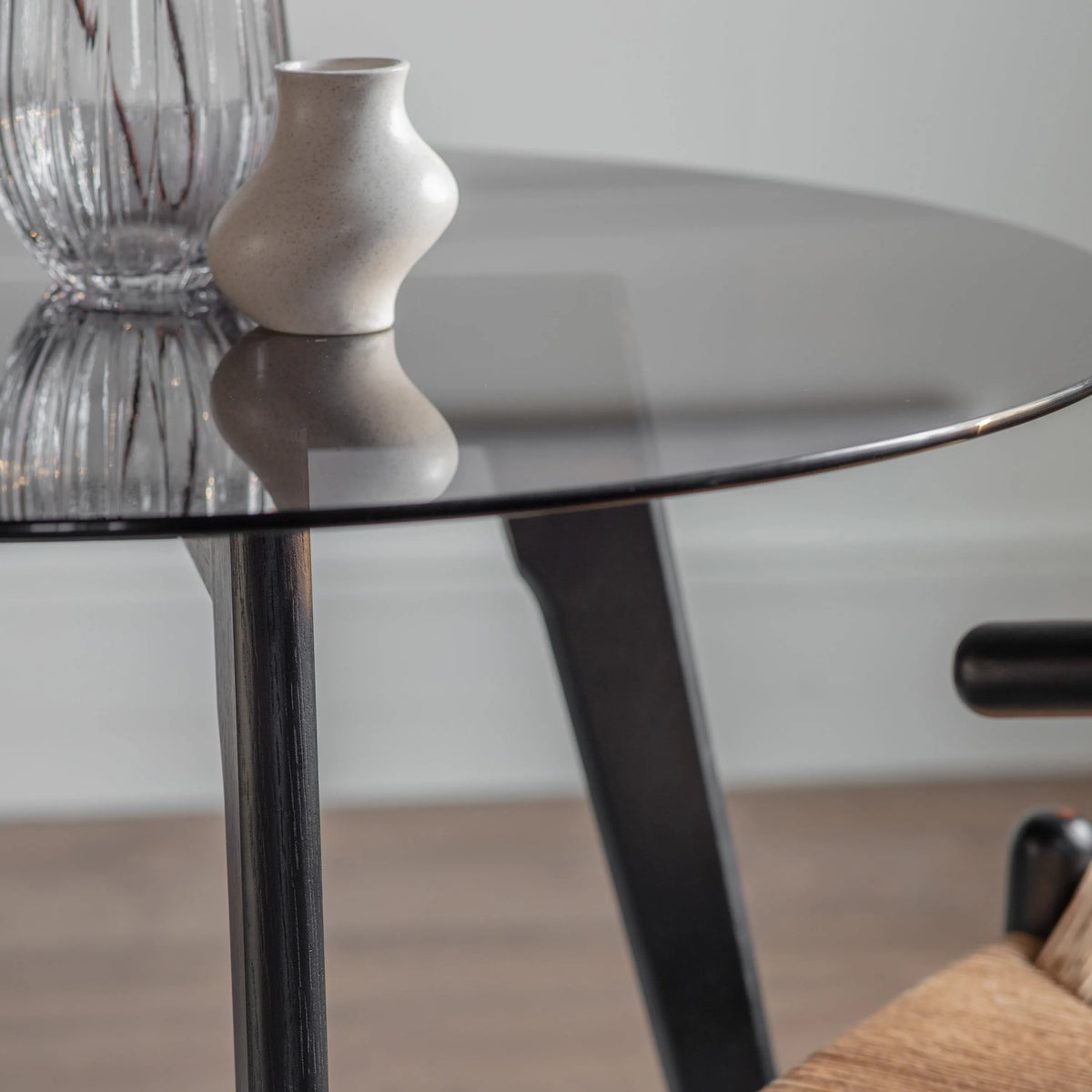 Blair black round dining table smoked glass and oak detail