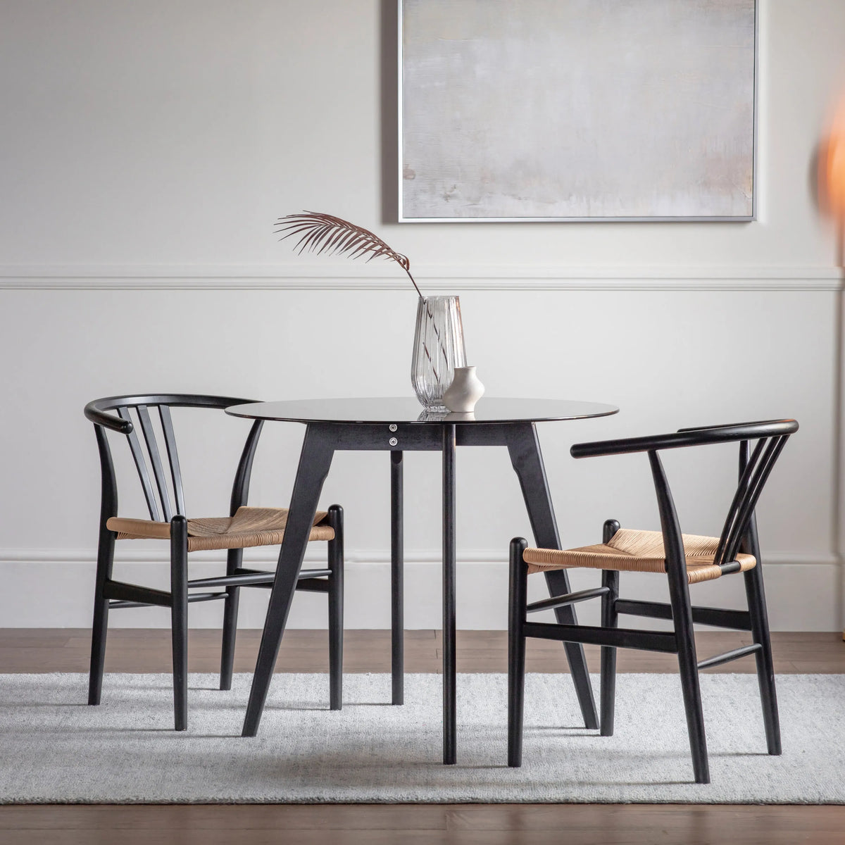 Blair black round dining table styled in a contemporary dining room