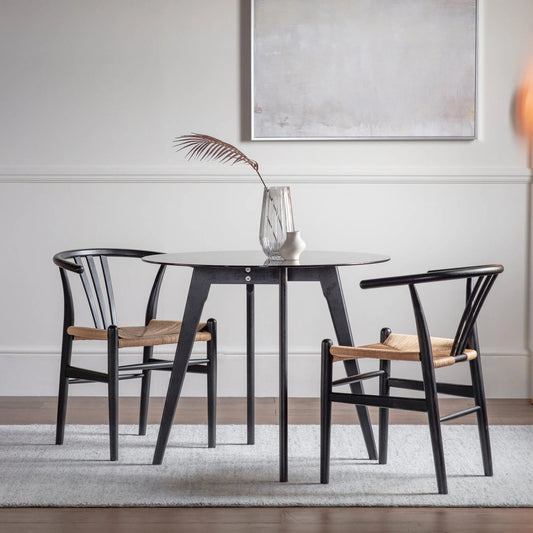 Blair black round dining table styled in a contemporary dining room