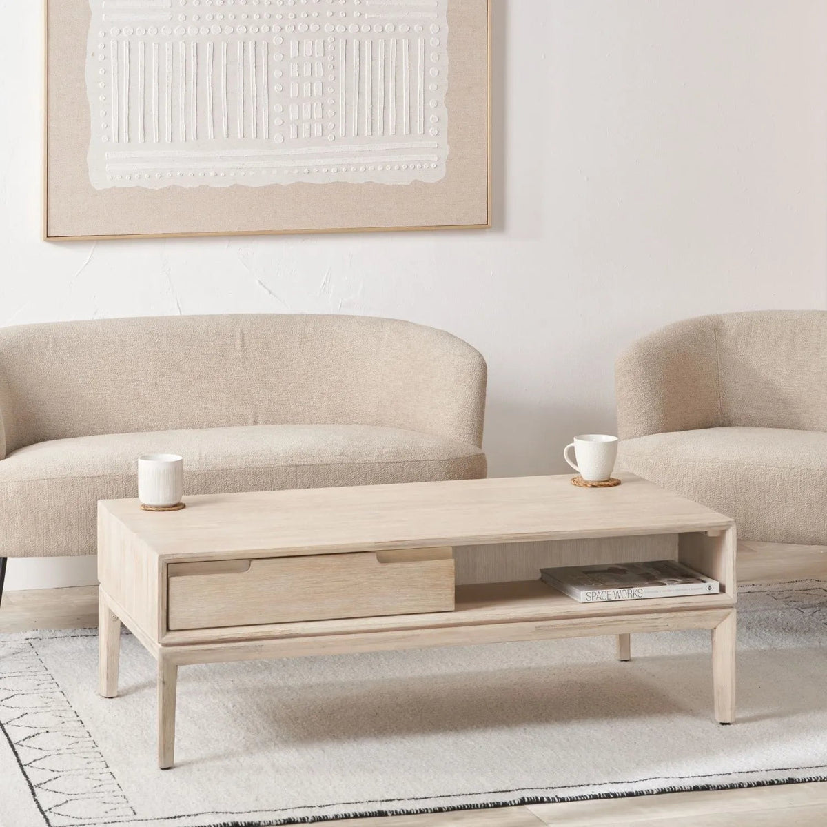 Gio white sand acacia wood coffee table styled in a neutral living room