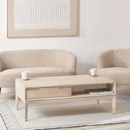 Gio white sand acacia wood coffee table styled in a neutral living room
