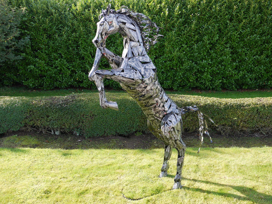 Large reflective horse statue in a rearing pose