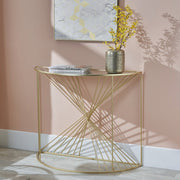 Liberty glass and gold half moon console table styled in an interior