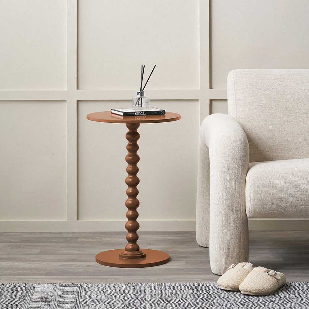 Margot terracotta bobble side table styled beside an armchair