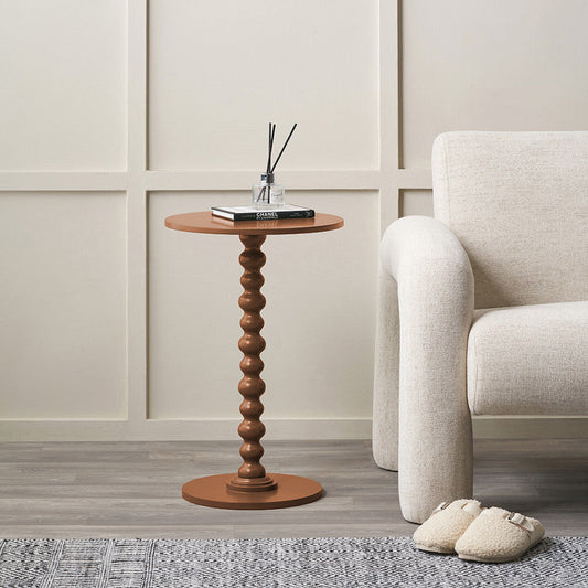 Margot terracotta bobble side table styled beside an armchair