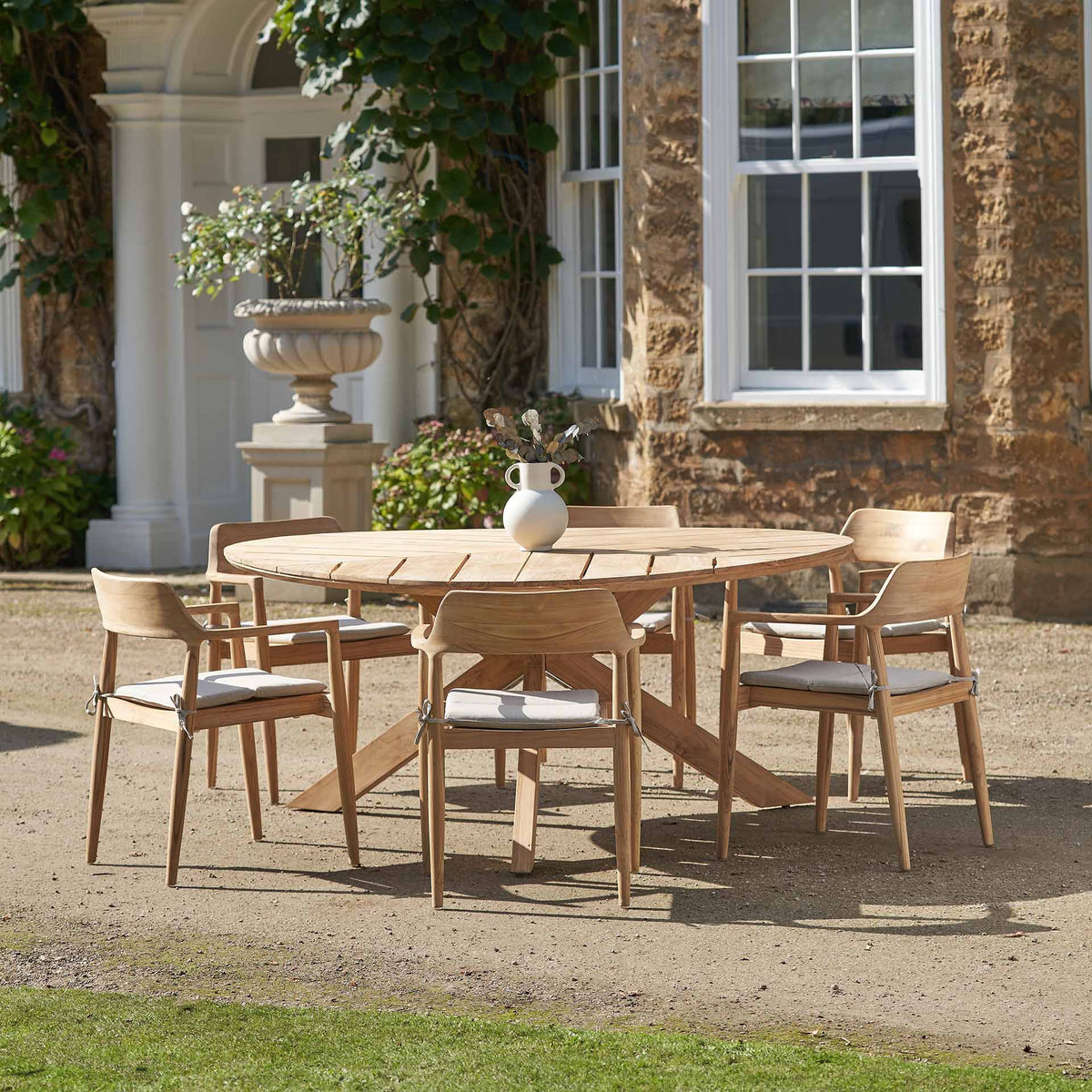 Reuleaux teak six-seater outdoor dining set in a terrace setting