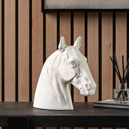 White metal horse head ornament displayed on a console